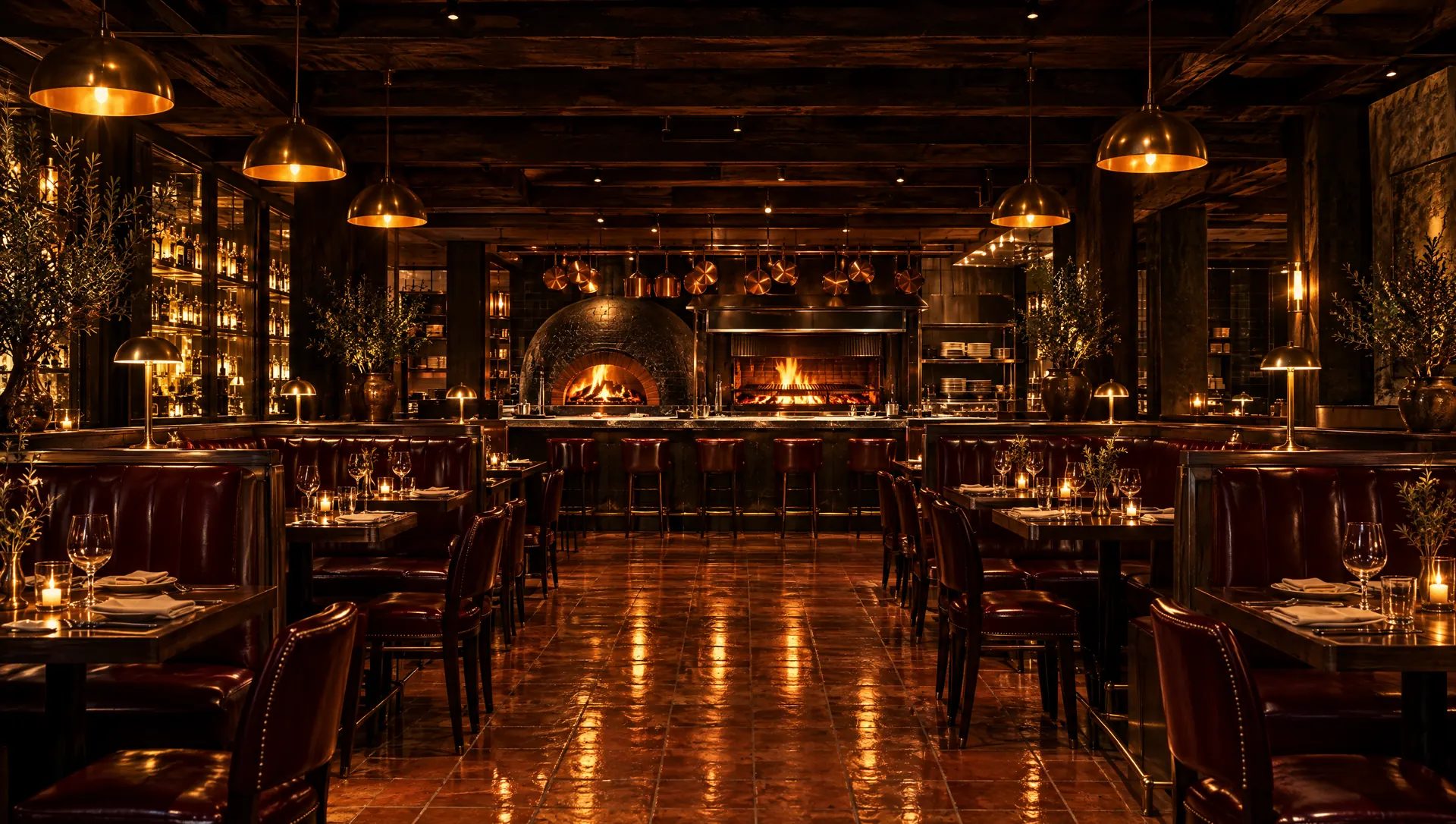 Dining room with leather banquettes facing an open kitchen with a wood-fired oven and grill